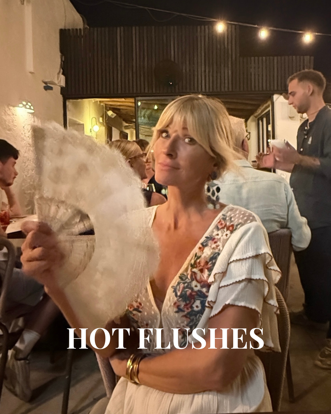 Ibiza date night with a hand fan on a hot-flush evening