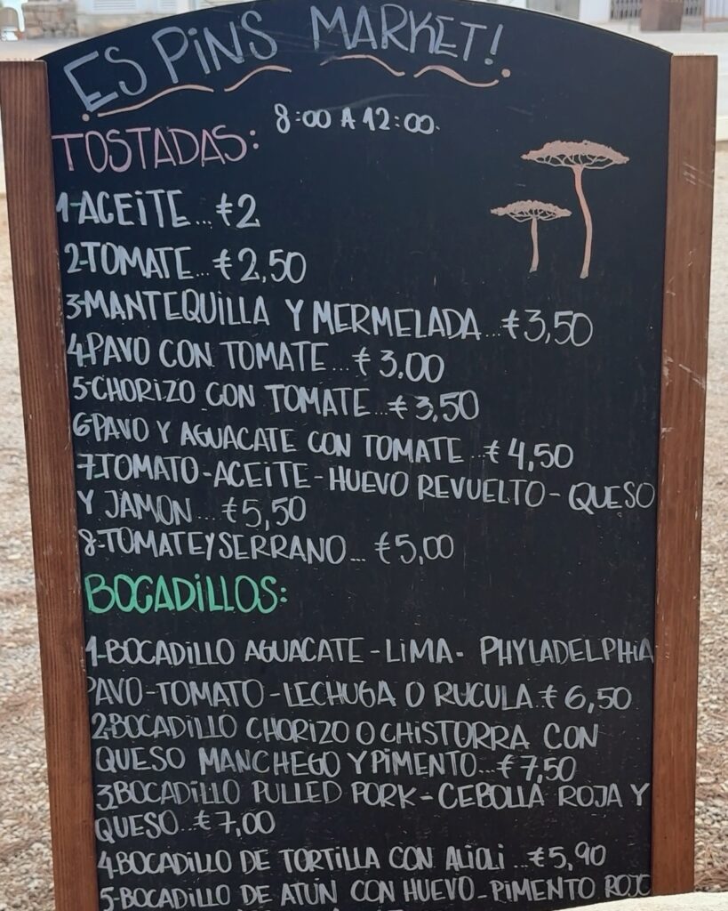 Es Pins Market chalkboard menu with tostadas and bocadillos